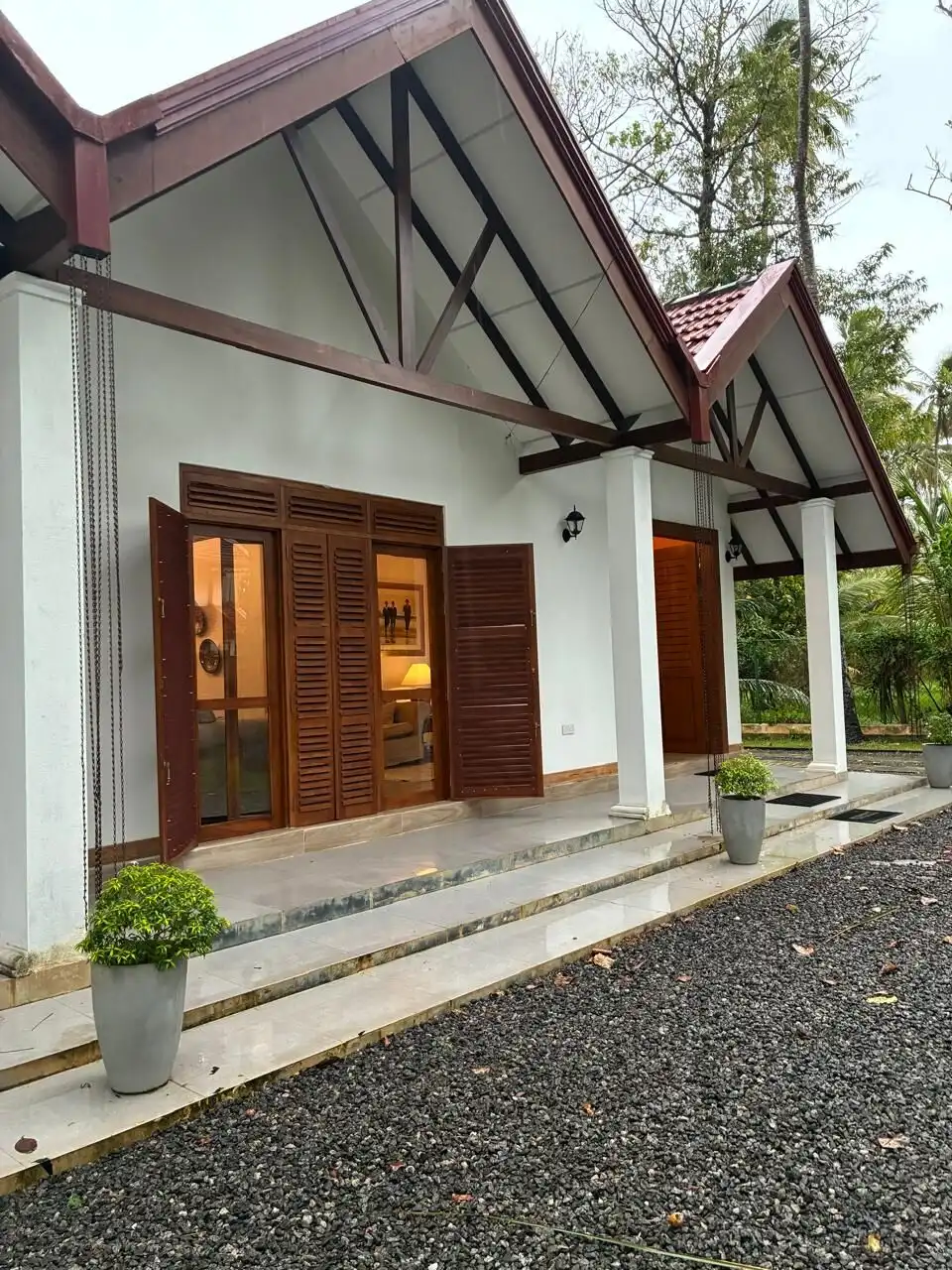 Beautiful house with wooden shutters and a spacious porch in Waikkal, Sri Lanka.