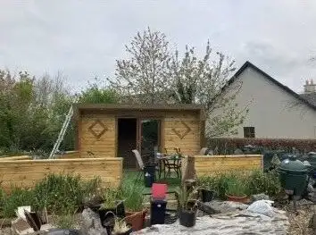 New wooden garden shed in Tooreen Kilcolgan Galway with outdoor furniture and garden plants.