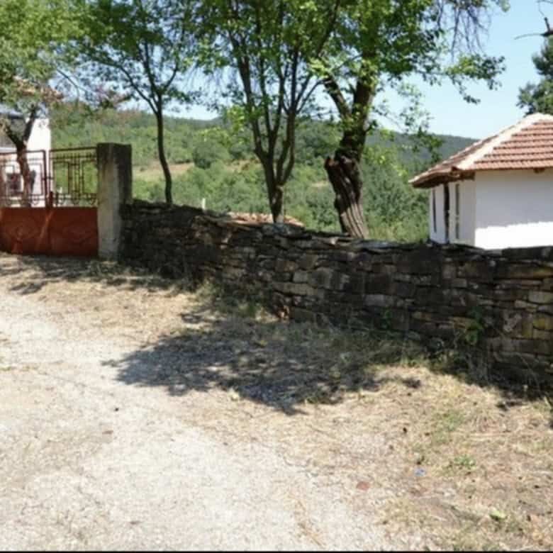 Beautiful view of traditional Bulgarian houses and lush greenery in Rogulyat Mlechevo.