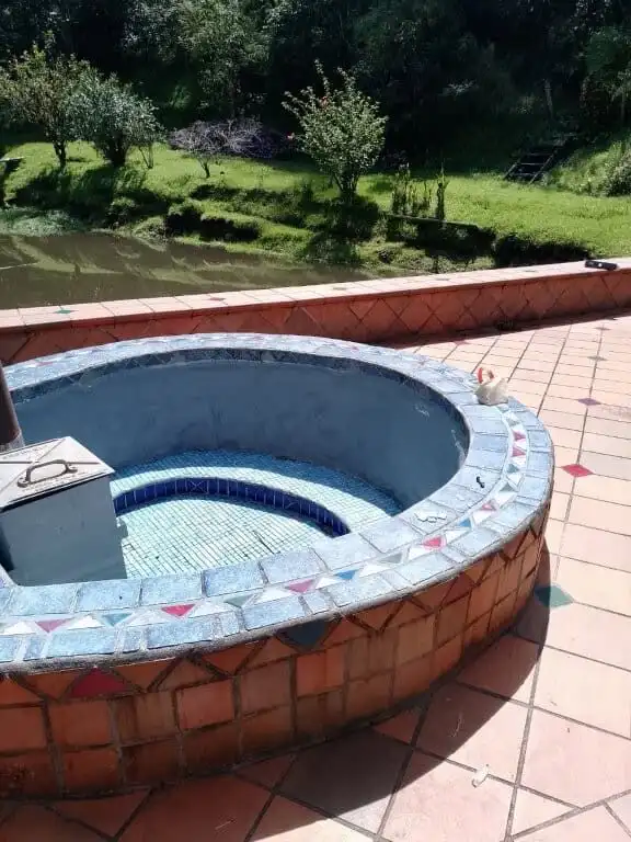 Hot tub overlooking lush green landscape at Hush Valley Estate, Rio Blanco, San Jose, Costa Rica.