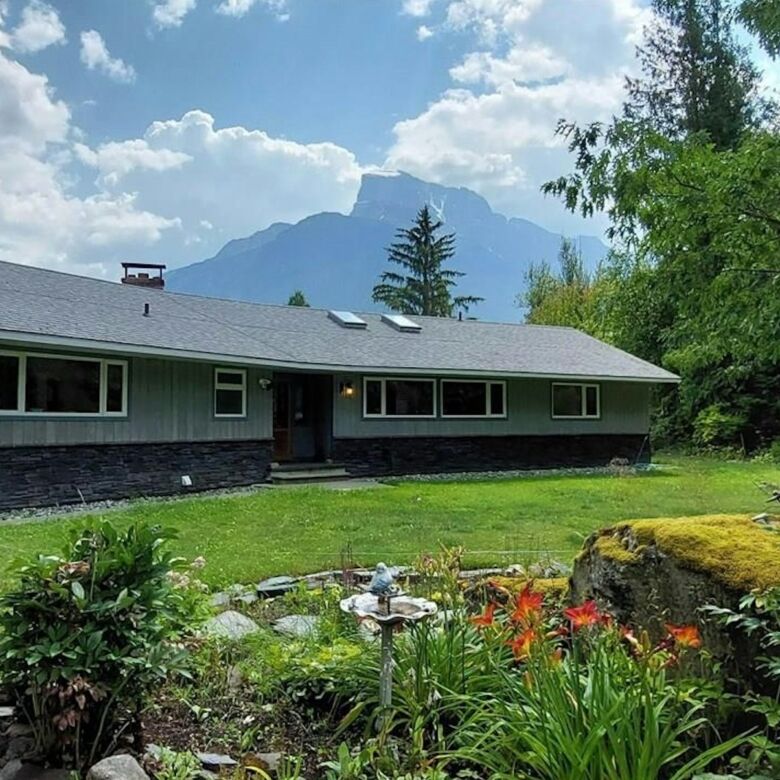 Beautiful 4-bedroom estate in Bella Coola, British Columbia, with scenic mountain views and lush gar.