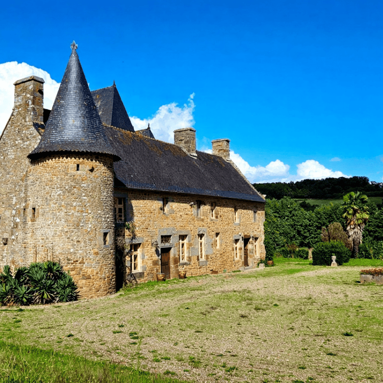 Historic Normandy castle with turrets and stone walls for sale.