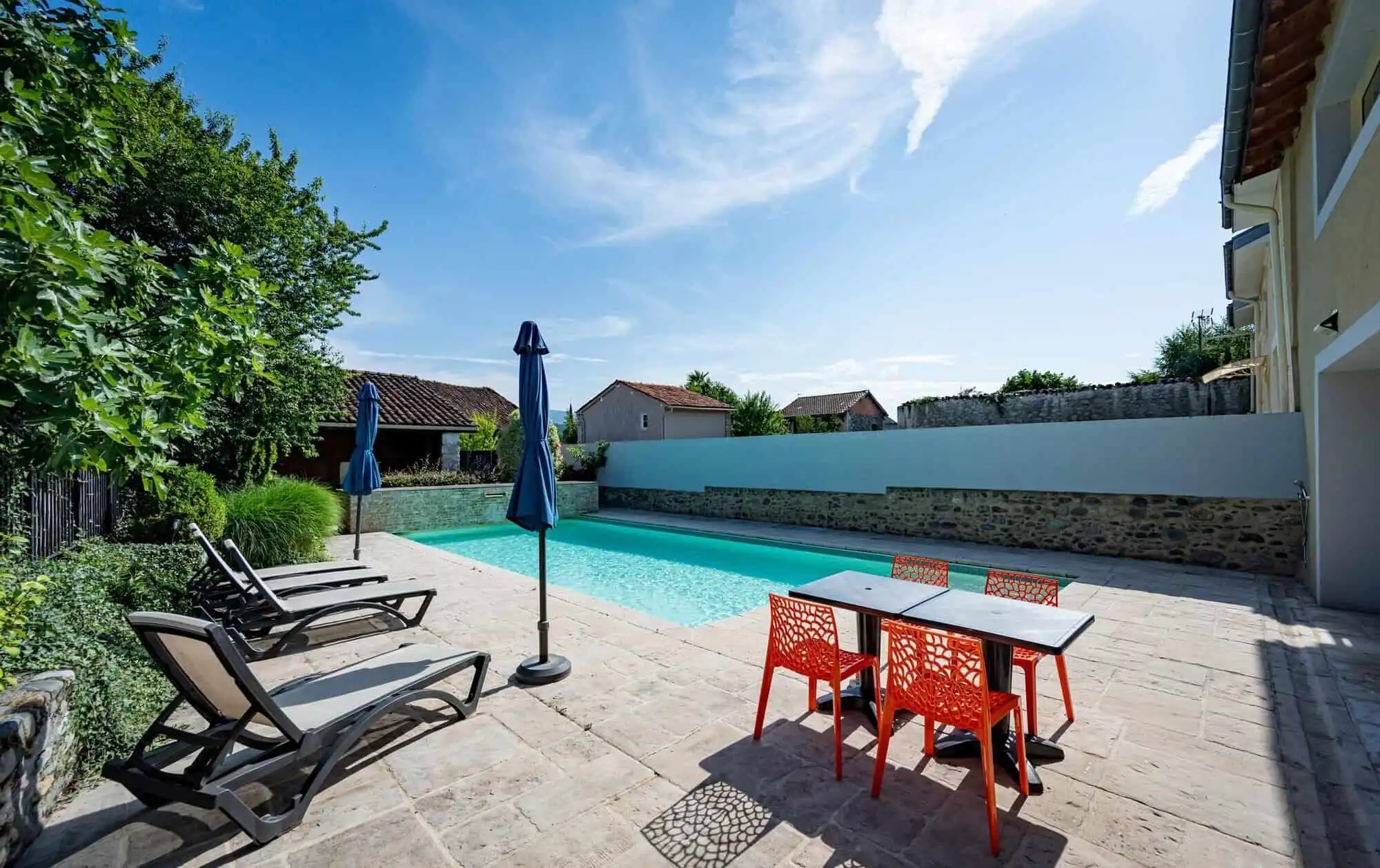 Pool and outdoor seating area at La Maison du Bonheur Bed and Breakfast in Ausson, Haute Garonne.