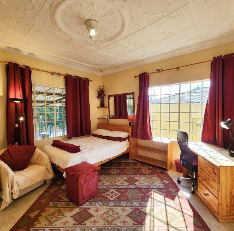 Spacious bedroom with large windows and elegant decor in Albertville, Johannesburg South.