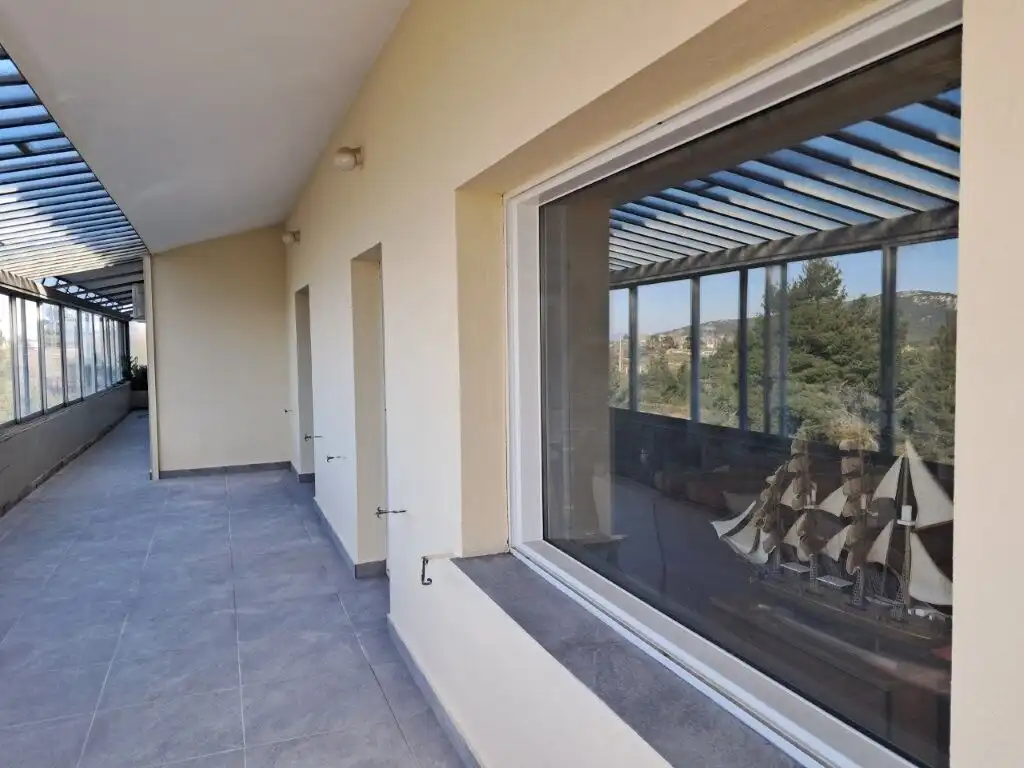 Balcony of a 4-bedroom house in Kapandriti Attica with panoramic countryside views.