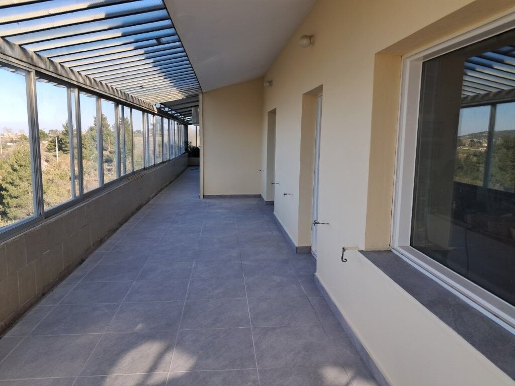 Modern Balcony with Views in Kapandriti Attica Balcony of a 4-bedroom house in Kapandriti Attica, featuring glass windows and scenic views.