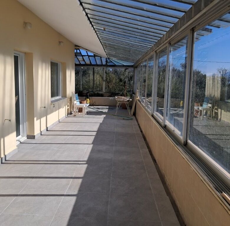 Spacious balcony with glass enclosure in a 4-bedroom home in Kapandriti, Attica, ideal for comfortab.