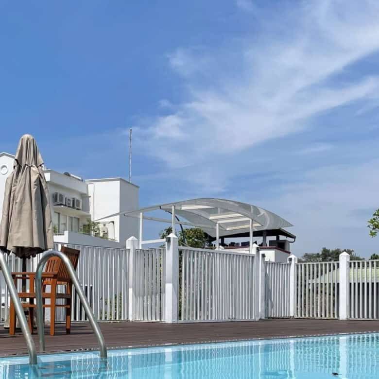 Poolside view of Luxury Loxwood House in Colombo, featuring a private swimming pool and outdoor seat.
