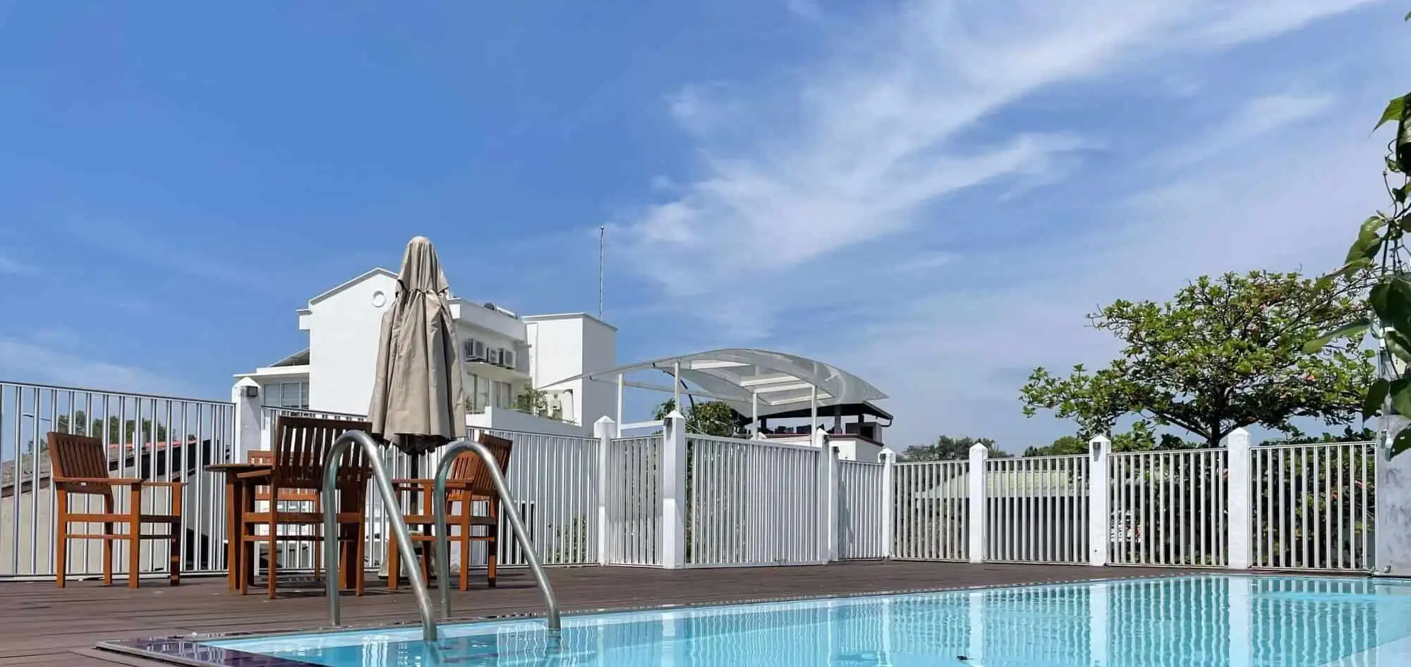 Poolside view of Luxury Loxwood House in Colombo, featuring a private swimming pool and outdoor seat.