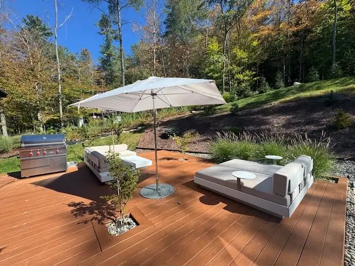 Luxury 5 Bed Home for Sale in Hanover, New Hampshire with spacious outdoor deck and scenic woodland.