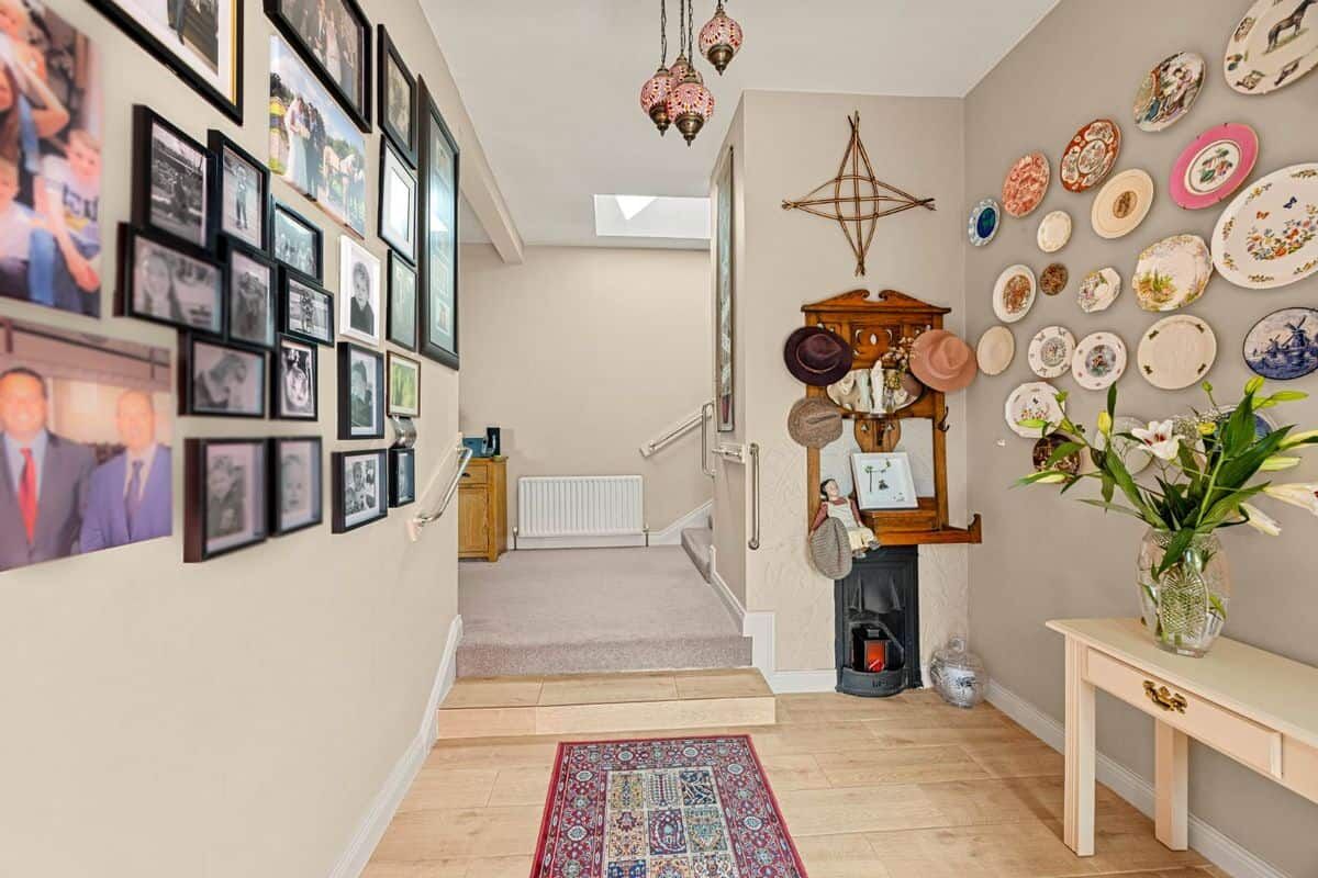 Charming Ballycorrigan 3-Bed House Entrance Cozy interior view of Springhill Lodge with decorative plates and family photos.
