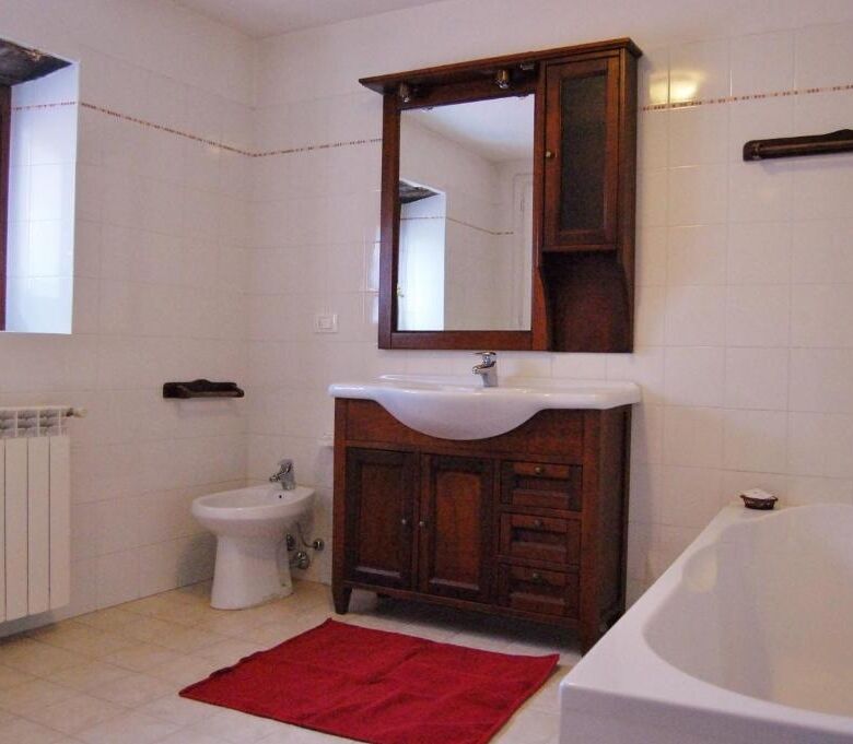 Spacious bathroom with bathtub, sink, and toilet in a luxurious Bagni di Lucca property.