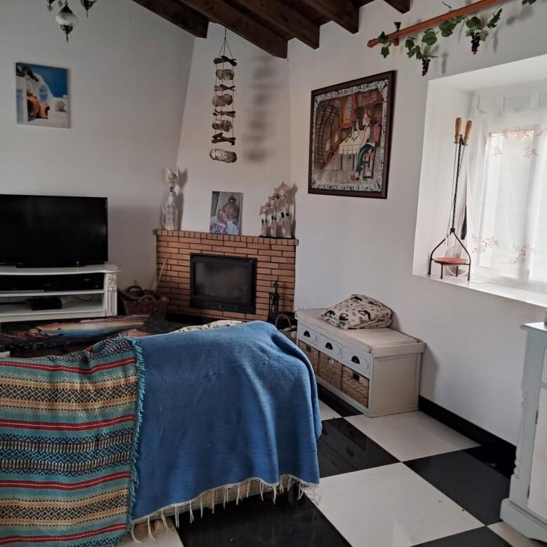 Cozy living room in a beautiful Algarve villa with traditional decor and fireplace. Perfect for rela.