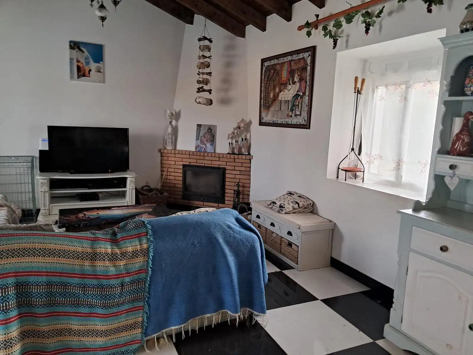 Cozy living room in a beautiful Algarve villa with traditional decor and fireplace. Perfect for rela.