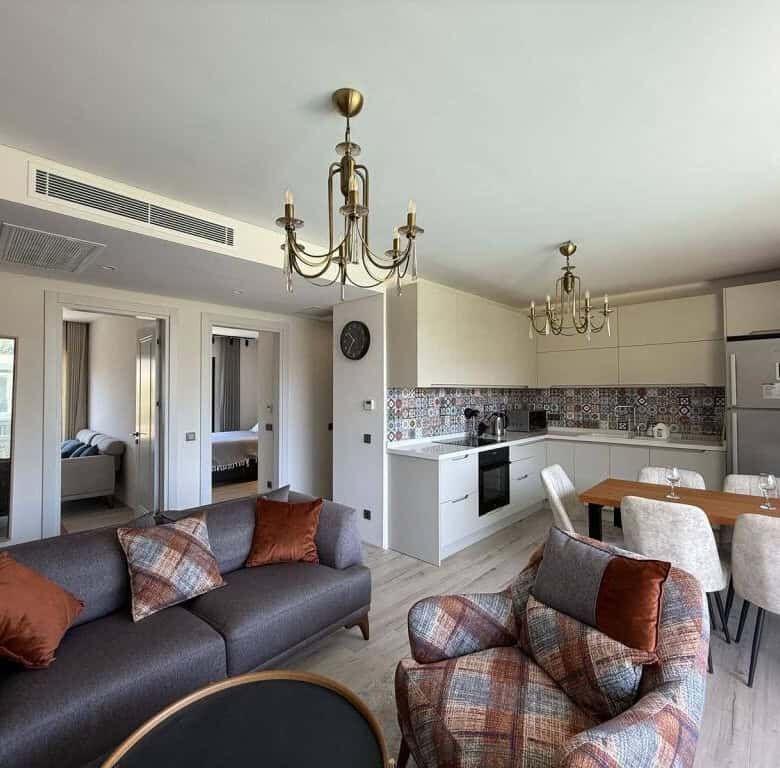 Spacious living room with open-plan kitchen and stylish furnishings in a luxury Yalıkavak Bodrum apa.