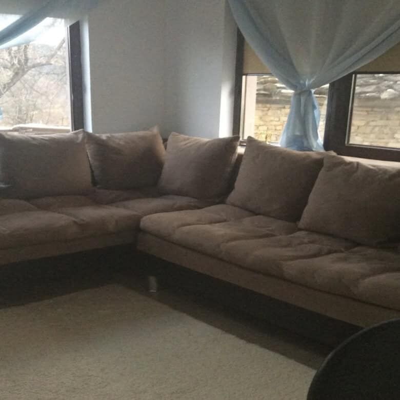 Spacious living room with large windows and cozy sofa in Rogulyat Mlechevo Troyan villa.
