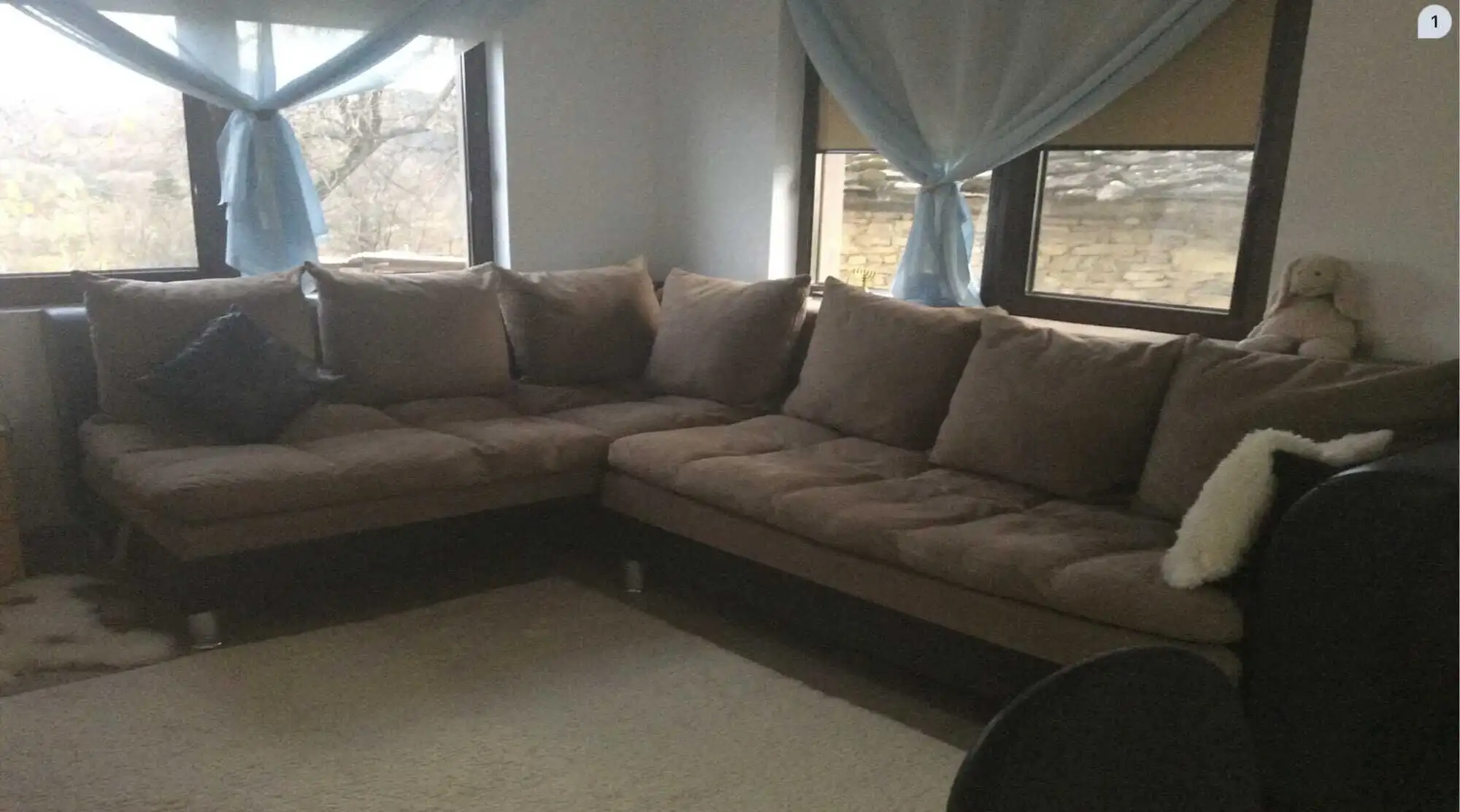 Spacious living room with large windows and cozy sofa in Rogulyat Mlechevo Troyan villa.