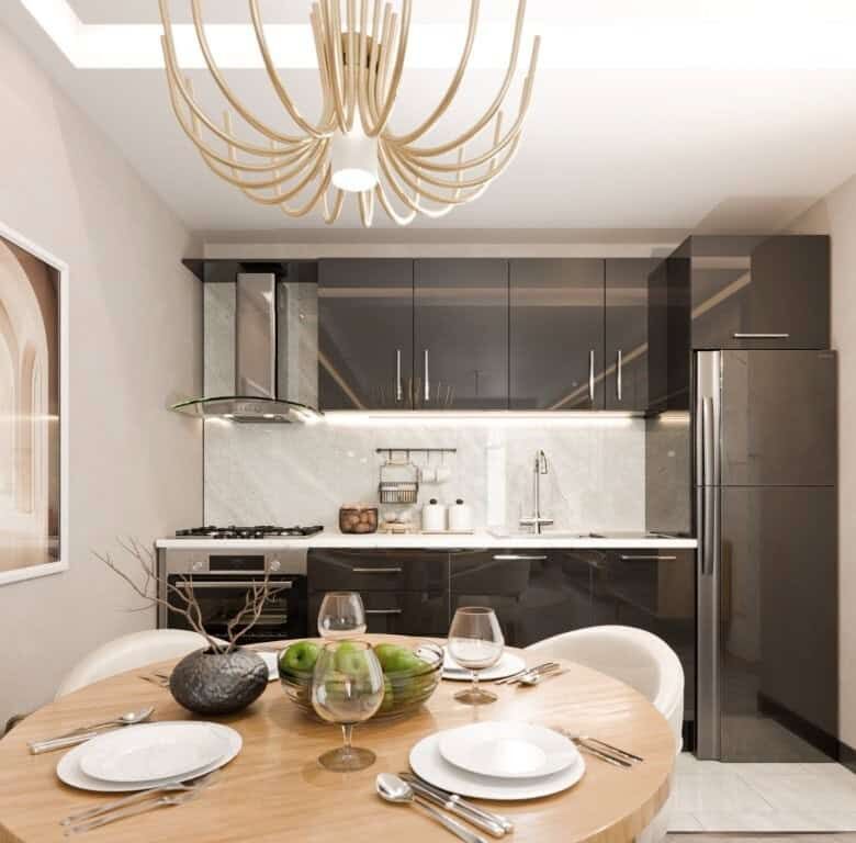 Contemporary kitchen with sleek black cabinets and marble backsplash.