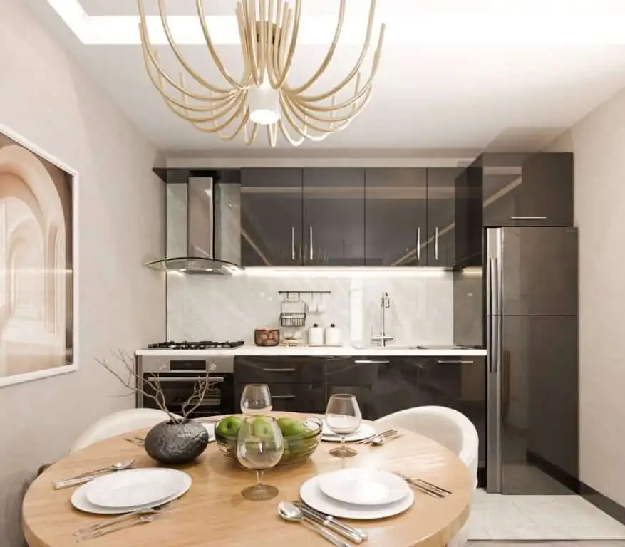Modern kitchen and dining area in Palm City Residencies, Kotor. Contemporary kitchen with sleek black cabinets and marble backsplash.