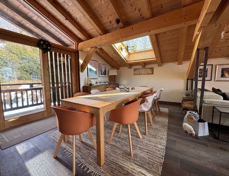 Spacious chalet dining area with wooden accents and large windows in Samoens.