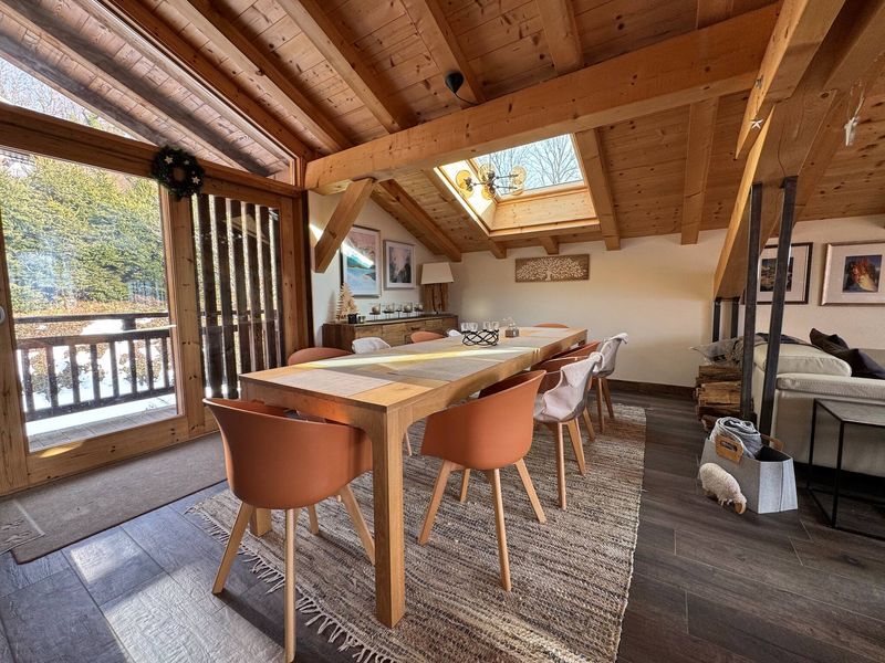 Luxury 5 Bed Chalet Interior Spacious chalet dining area with wooden accents and large windows in Samoens.