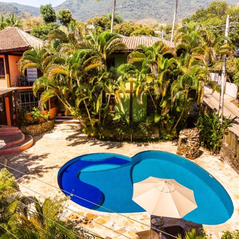 Boutique hotel with lush tropical gardens and a swimming pool in Ilhabela, ideal for investors seeki.
