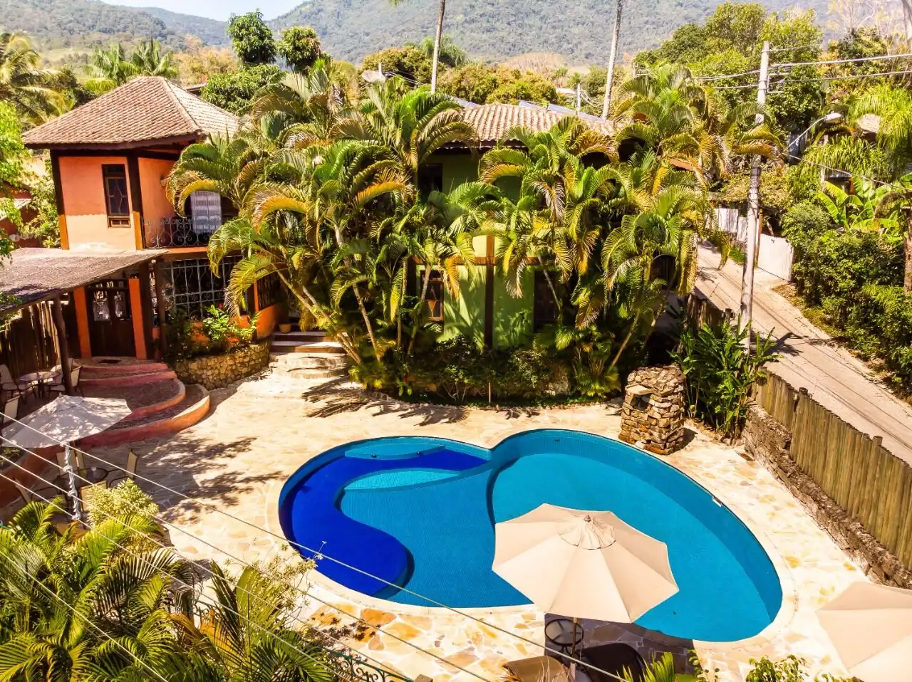 Boutique hotel with lush tropical gardens and a swimming pool in Ilhabela, ideal for investors seeki.