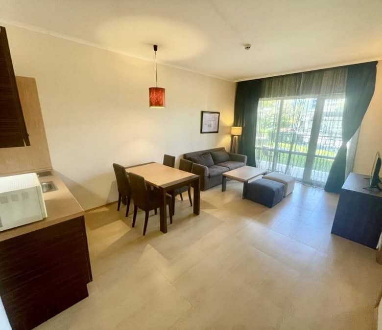 Bright living room with large windows and balcony access.