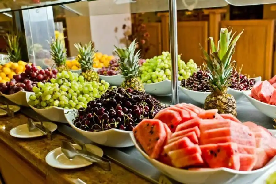 Bright fruit display at Majestic Sunny Beach hotel buffet Colorful assortment of fresh grapes, pineapples, and watermelon slices at a hotel breakfast buffet.