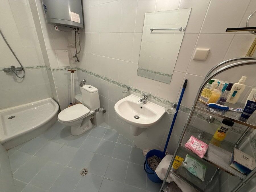 Clean, furnished bathroom with shower, toilet, and sink at Vineyards SPA Resort.