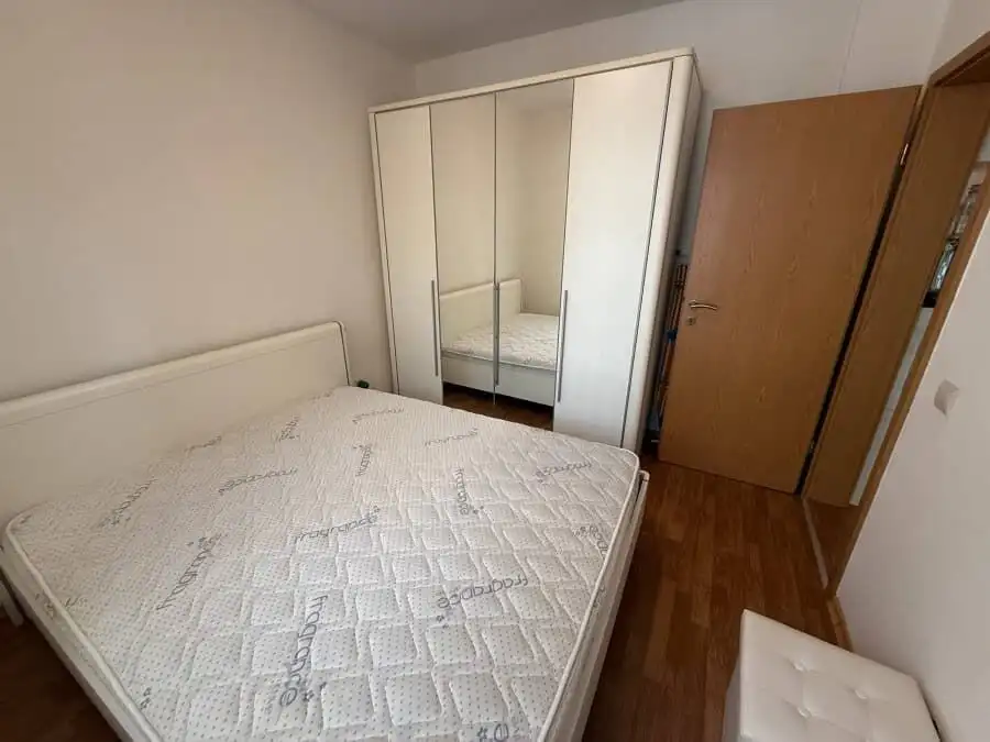 Furnished bedroom with double bed and wardrobe in Vineyards SPA Resort, 2 km from the sea.