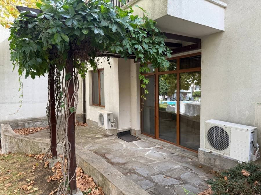 Furnished 1-bedroom apartment entrance with glass doors at Vineyards SPA Resort, 2 km from the sea.