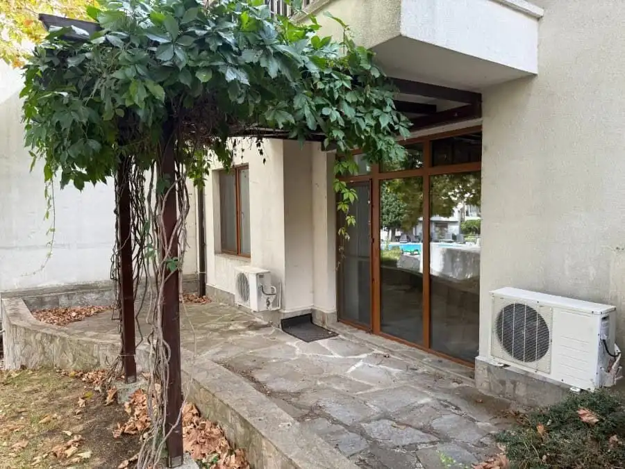 Furnished 1-bedroom apartment entrance with glass doors at Vineyards SPA Resort, 2 km from the sea.