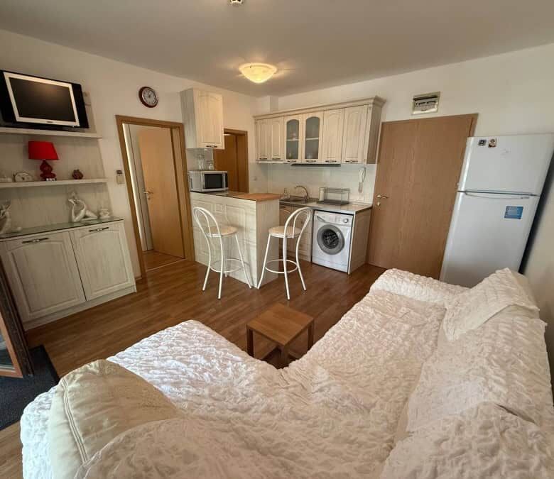 Bright interior of a furnished 1-bedroom apartment near the sea in Vineyards SPA Resort.