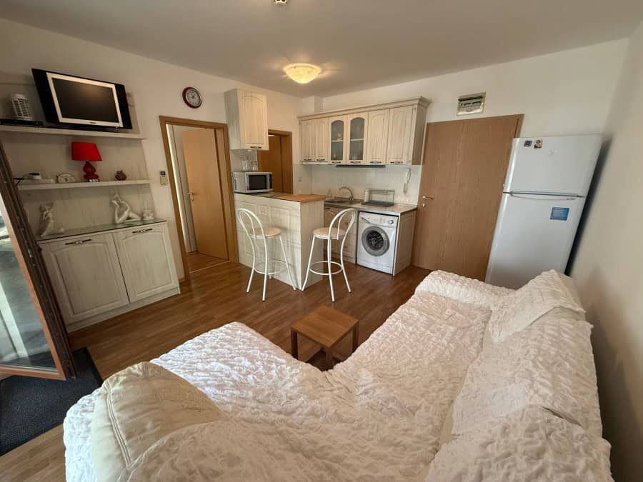 Bright interior of a furnished 1-bedroom apartment near the sea in Vineyards SPA Resort.
