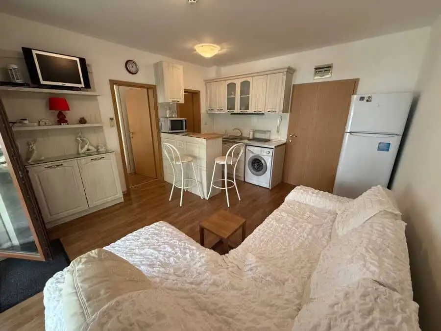 Bright interior of a furnished 1-bedroom apartment near the sea in Vineyards SPA Resort.