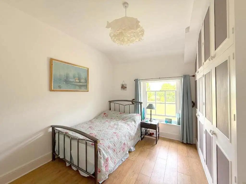 Luxury 3 Bed Apartment in Milton Keynes Spacious bedroom with vintage bed frame and natural light in Wavendon House Drive.