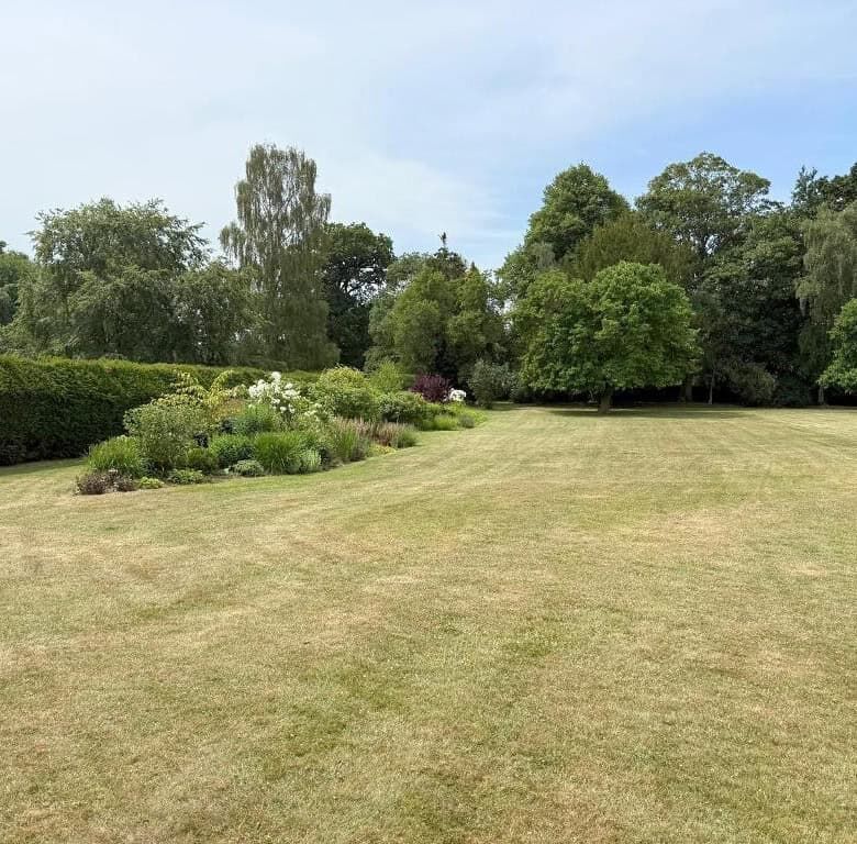 Elegant outdoor garden space with lush greenery and trees in Milton Keynes.