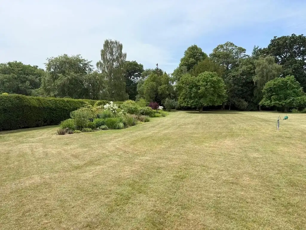 Luxury 3 Bed Apartment for Sale Elegant outdoor garden space with lush greenery and trees in Milton Keynes.