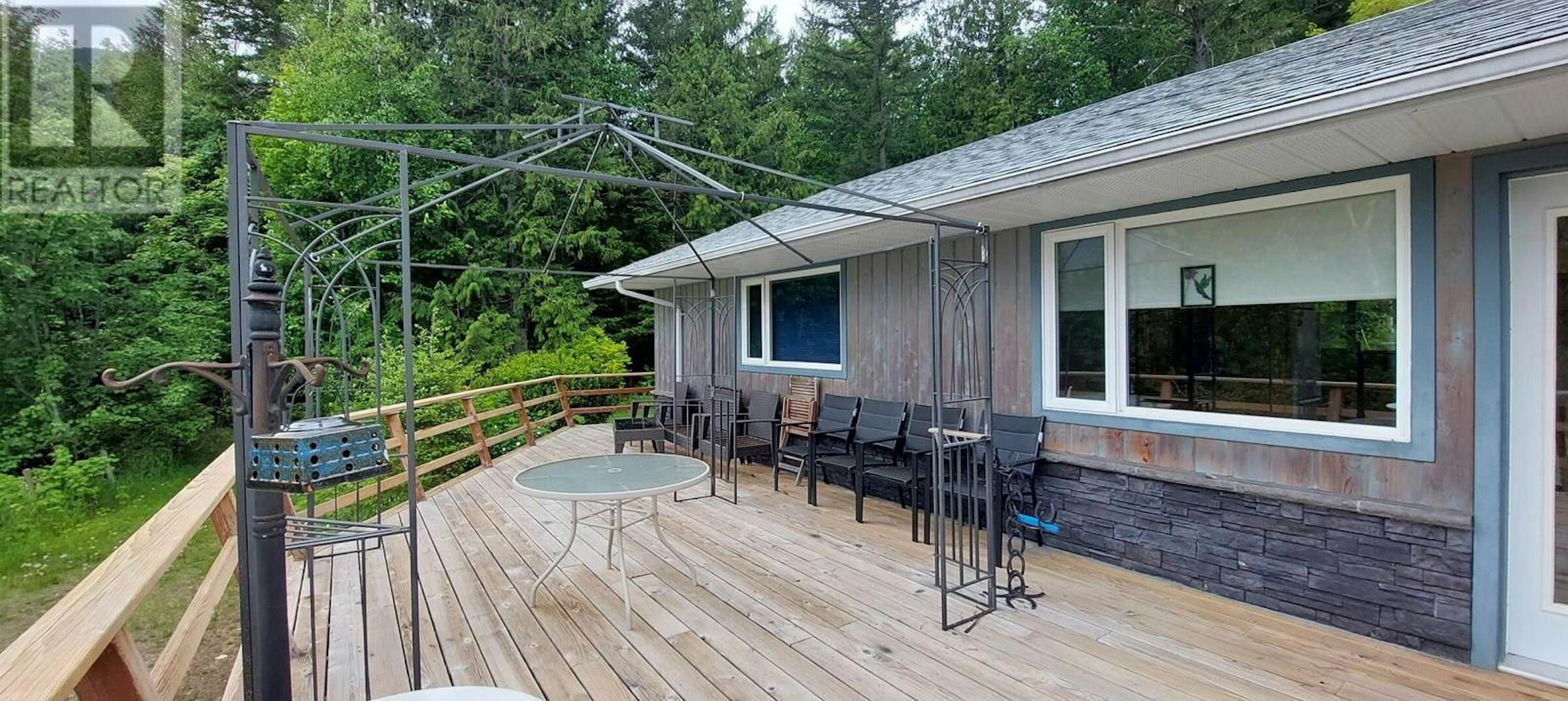 Excellent 4 Bed Estate in Bella Coola BC Spacious outdoor deck with seating and scenic views in Bella Coola, British Columbia.