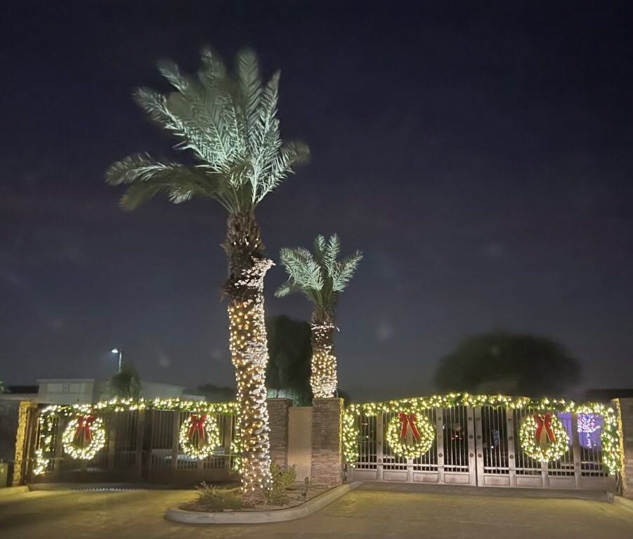 Luxury 4 Bed Villa for Sale in Indio, California Luxury 4 Bed Villa for Sale in Indio, California with festive holiday lights and palm trees.