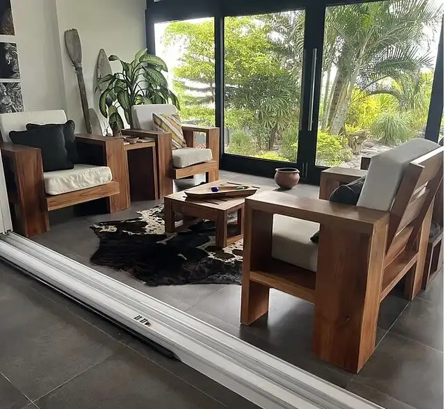 Elegant living room with modern wooden furniture and large glass doors.