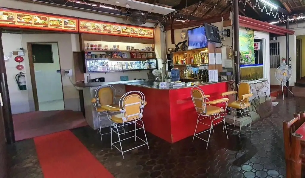 Charming resort hotel bar with vibrant decor and seating area in Cavite for sale.
