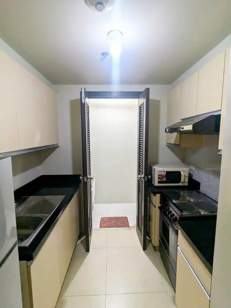 Compact kitchen in Kroma Tower Manila with modern appliances and sleek cabinetry.