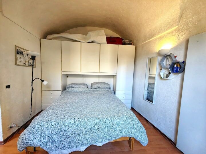Bedroom apartment for sale in Bordighera Alta, Liguria, featuring a unique arched ceiling and modern.