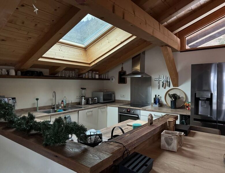 Spacious kitchen in a luxury chalet with skylight and modern appliances in Samoens.