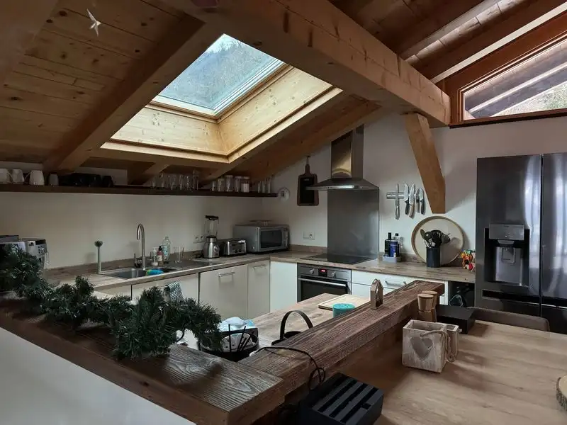 Spacious kitchen in a luxury chalet with skylight and modern appliances in Samoens.