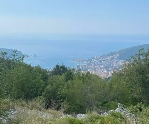Beautiful land for sale in Budva with panoramic views of the Adriatic Sea and surrounding landscape.