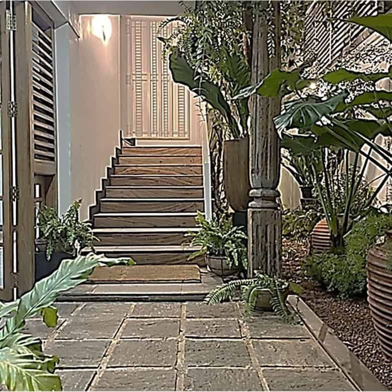 Elegant entrance staircase at Loxwood House, Colombo, showcasing lush greenery and modern design.
