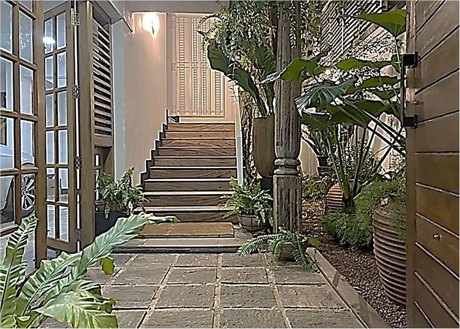 Elegant entrance staircase at Loxwood House, Colombo, showcasing lush greenery and modern design.